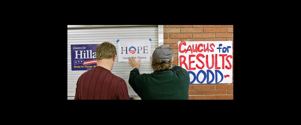 photograph of people hanging political signs