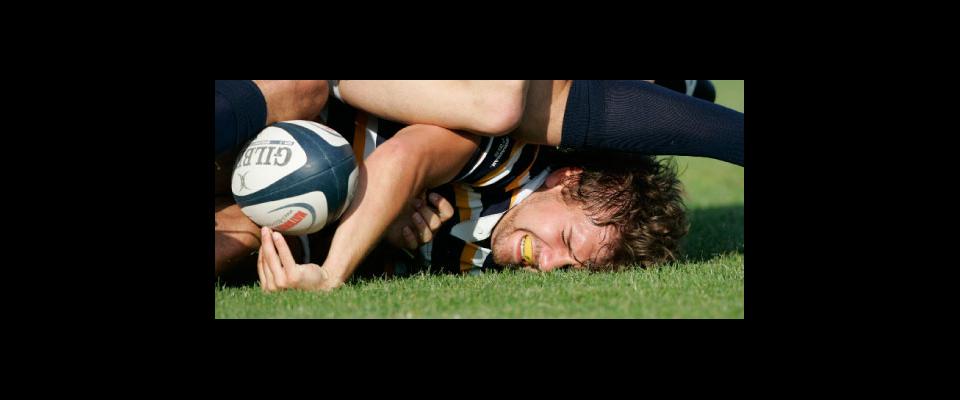 photograph of a rugby player at the bottom of a scrum