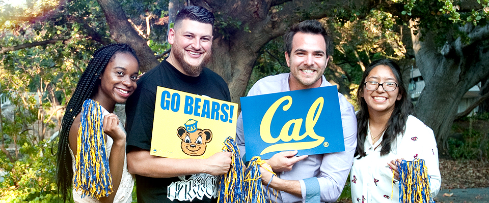 group of people smiling with Cal flags