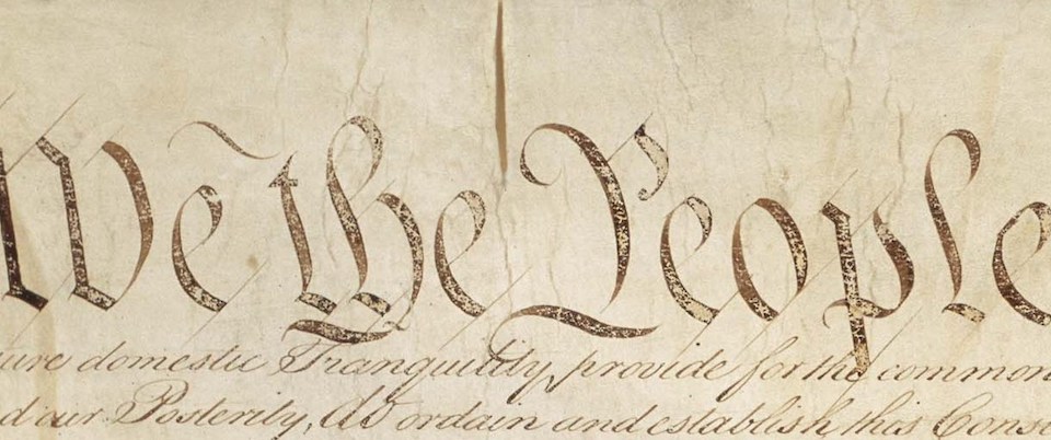 Cropped photo of the opening phrase of the Constitution
