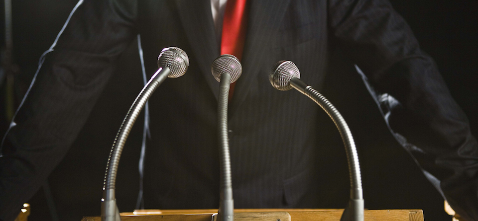 Photo of a podium with someone speaking at it
