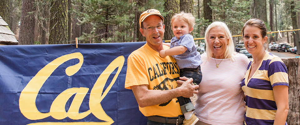 Three generations of Lair campers in front of Cal flag