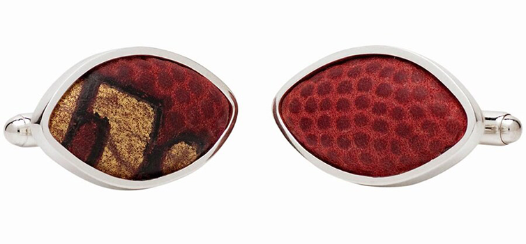 pair of silver cufflinks with football leather