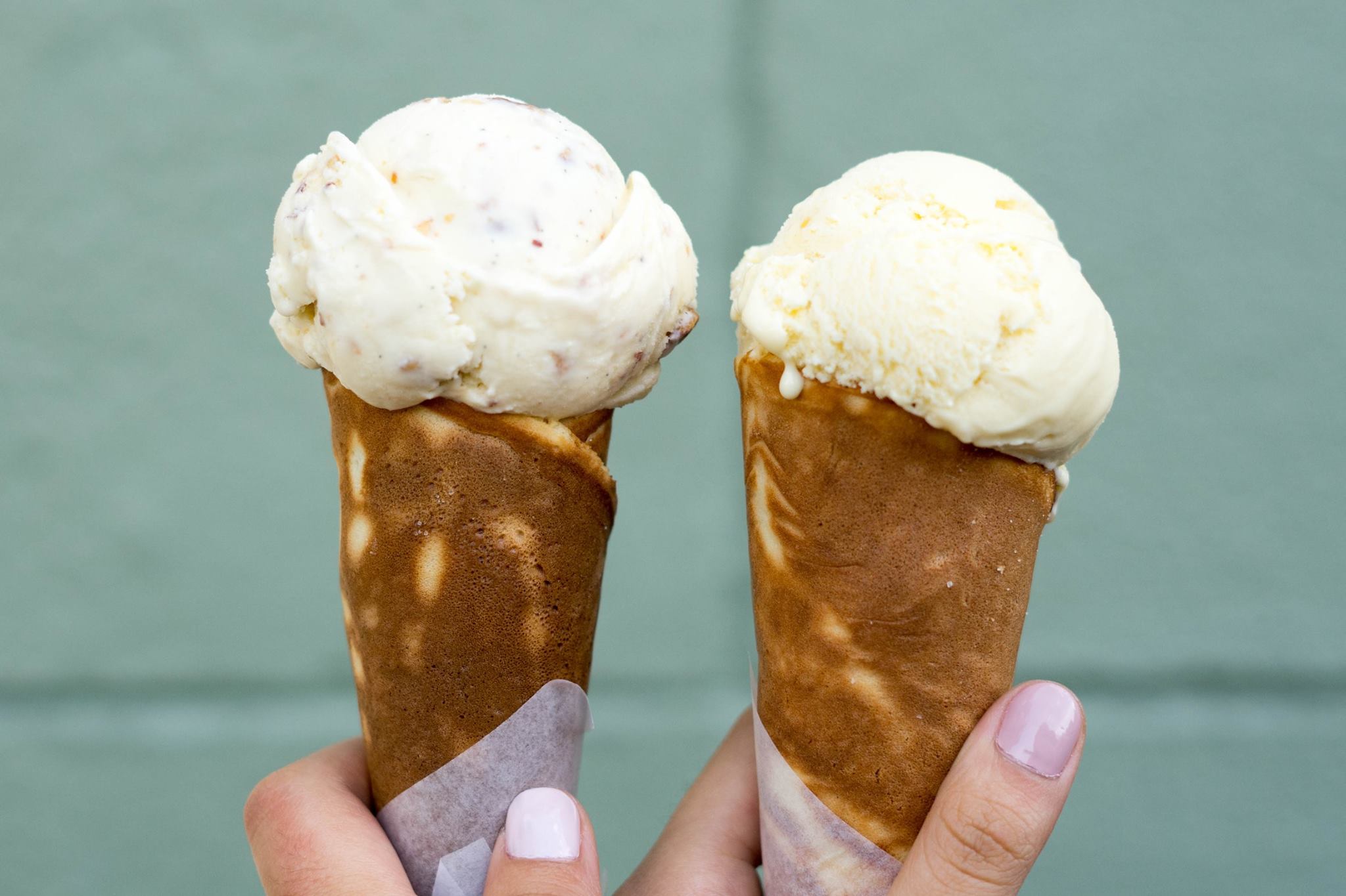 Two ice cream cones held side by side