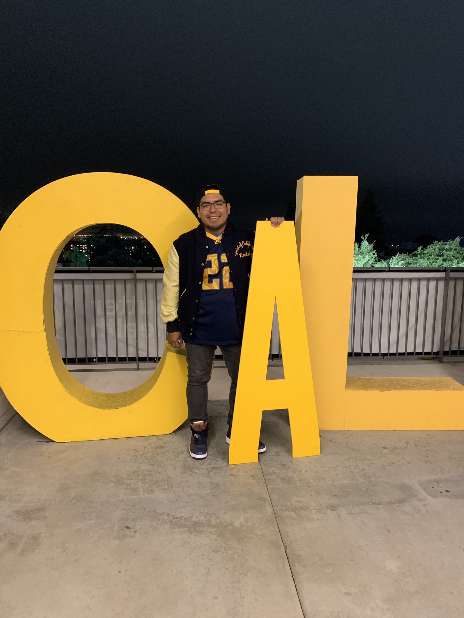 Cal student posing with giant letters that spell out "CAL"
