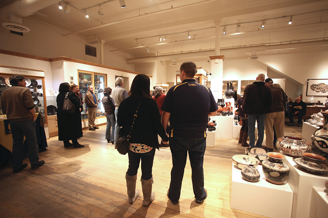 Rachel and Andrew Wysong holding hands in an exhibit
