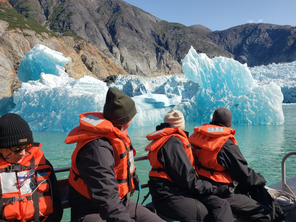 Travelers next to iceberg
