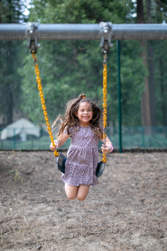 Girl smiling on a swing