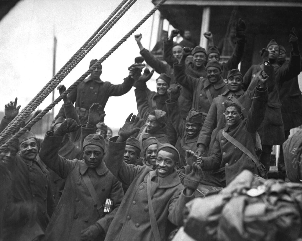 African Americans, members of 369th Colored Infantry, wave from a troop ship.