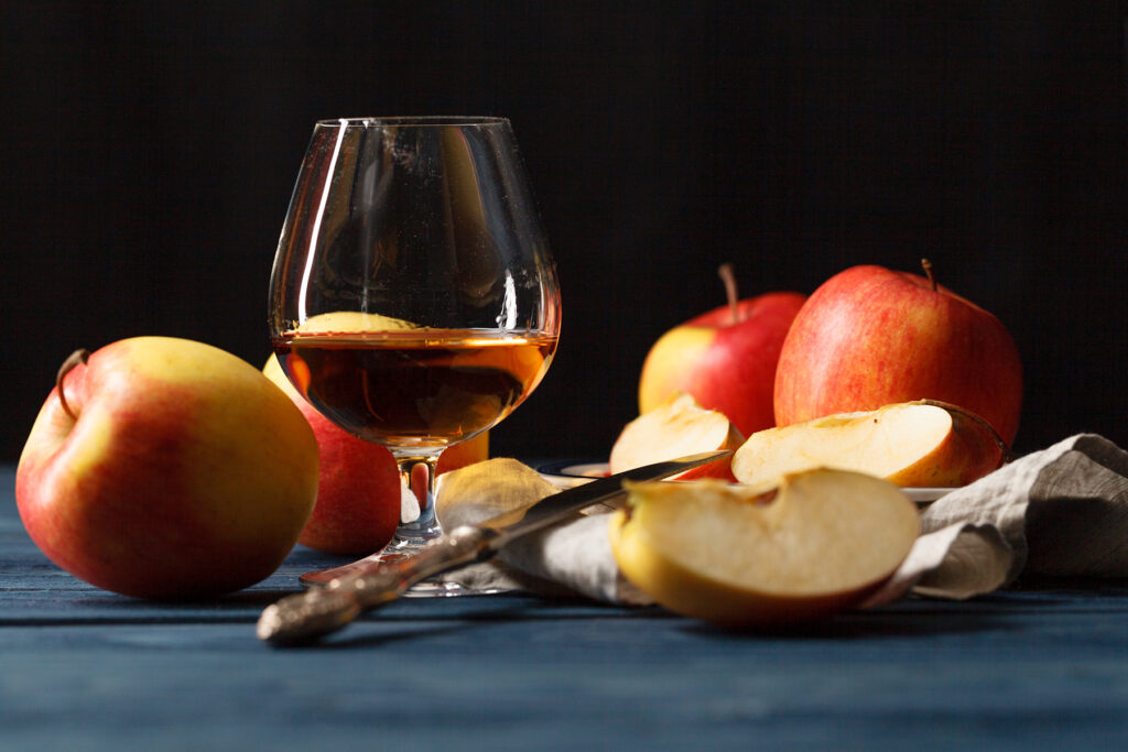 Glass of Calvados Brandy and red apples