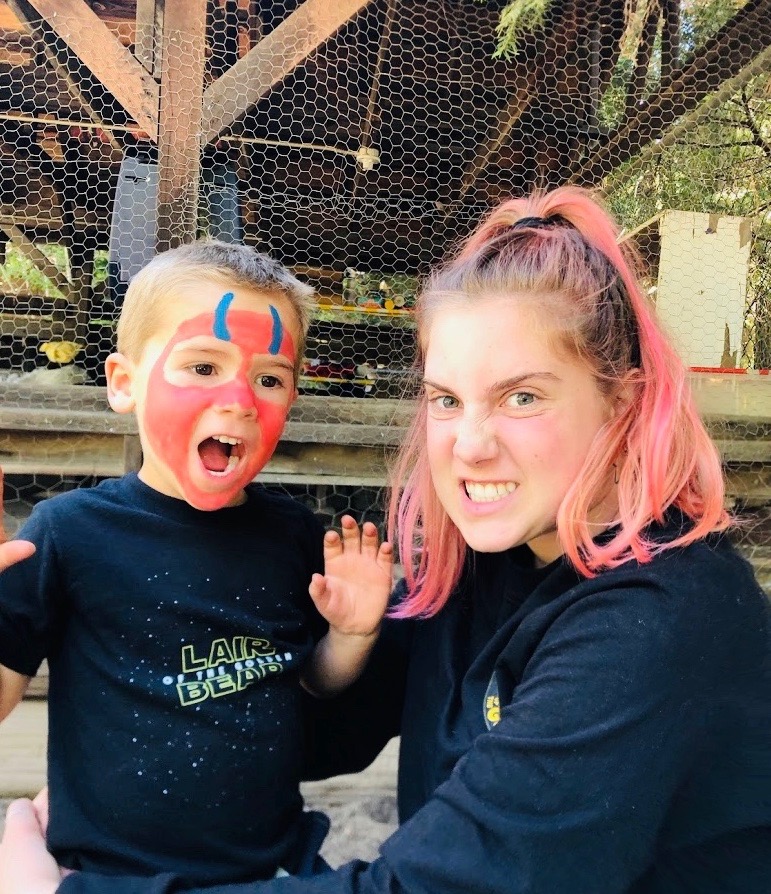 Lair staffer with kid in facepaint