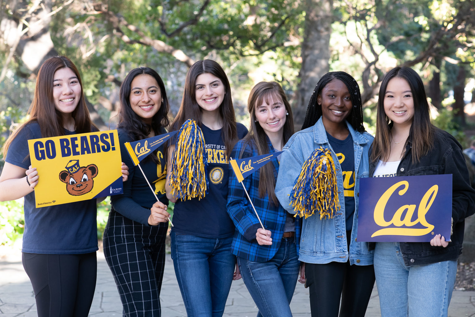 Young women dressed in and holding Cal gear