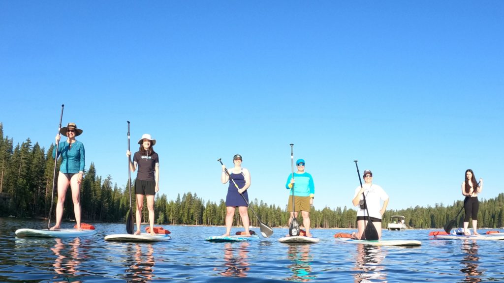stand up paddleboarders on lake