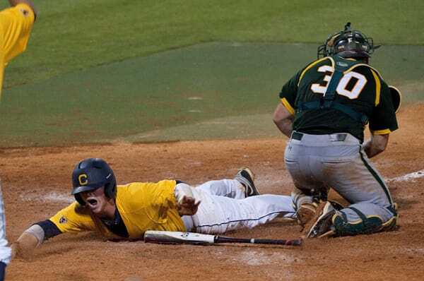 Cal athlete Tony Renda sliding in to home plate to win a game.