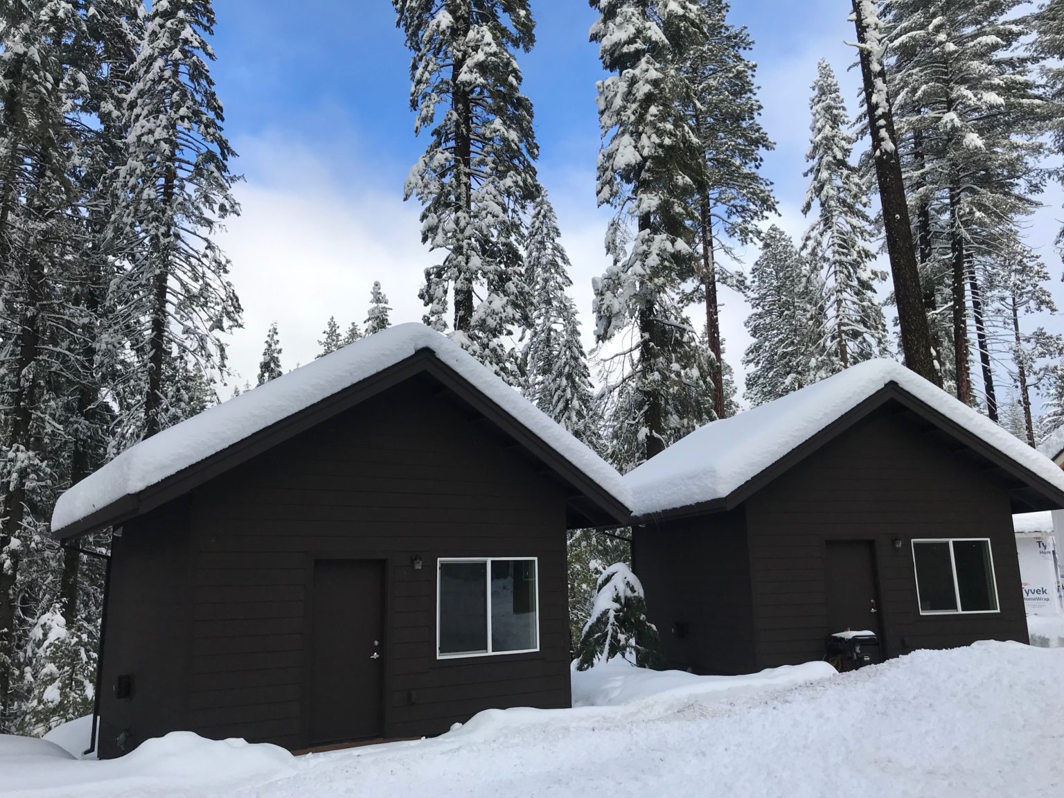 Year round cabins at Camp Oski in the winter covered in snow