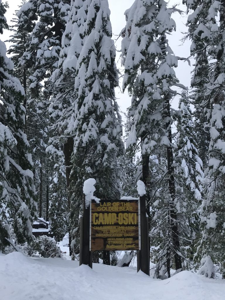 Camp Oski sign covered in snow