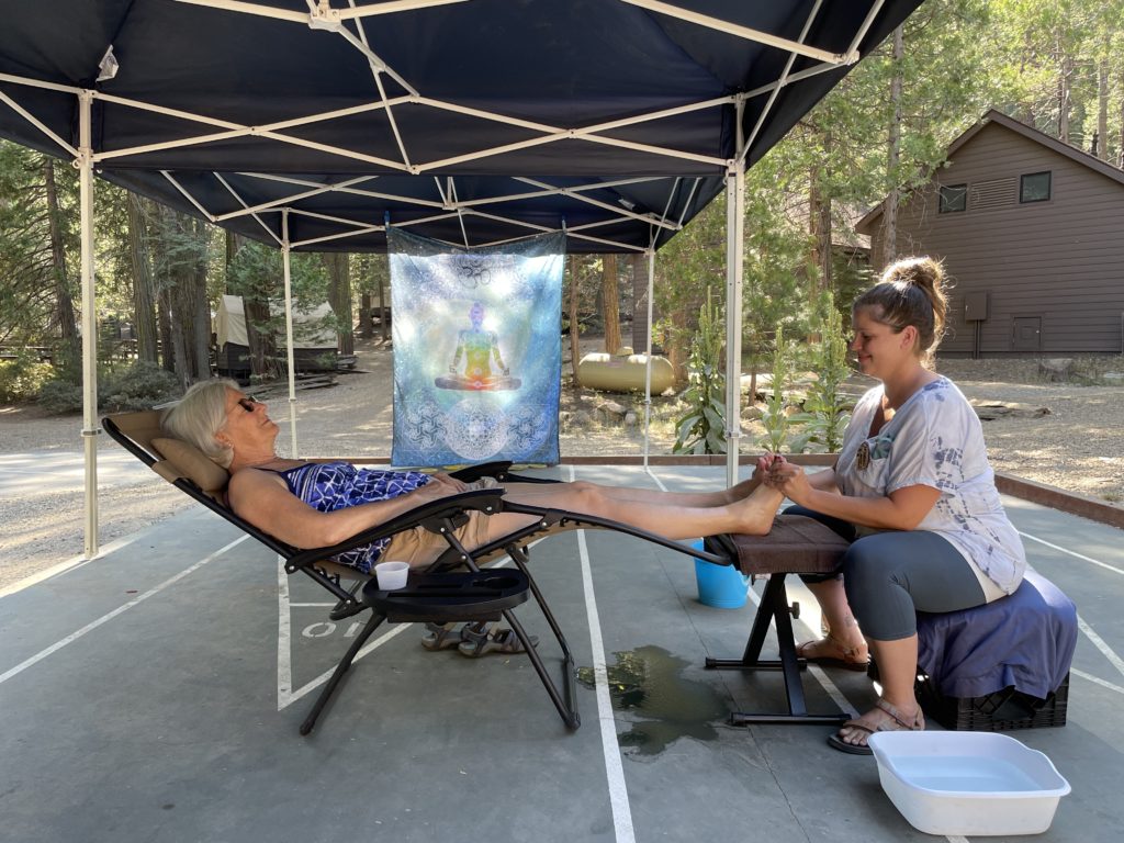 woman receiving foot massage outside