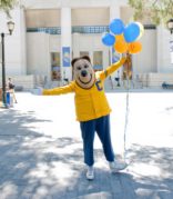 oski holding balloons