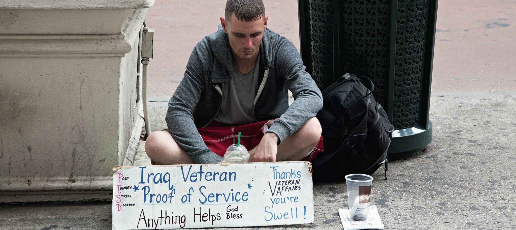 Homeless veteran with sign
