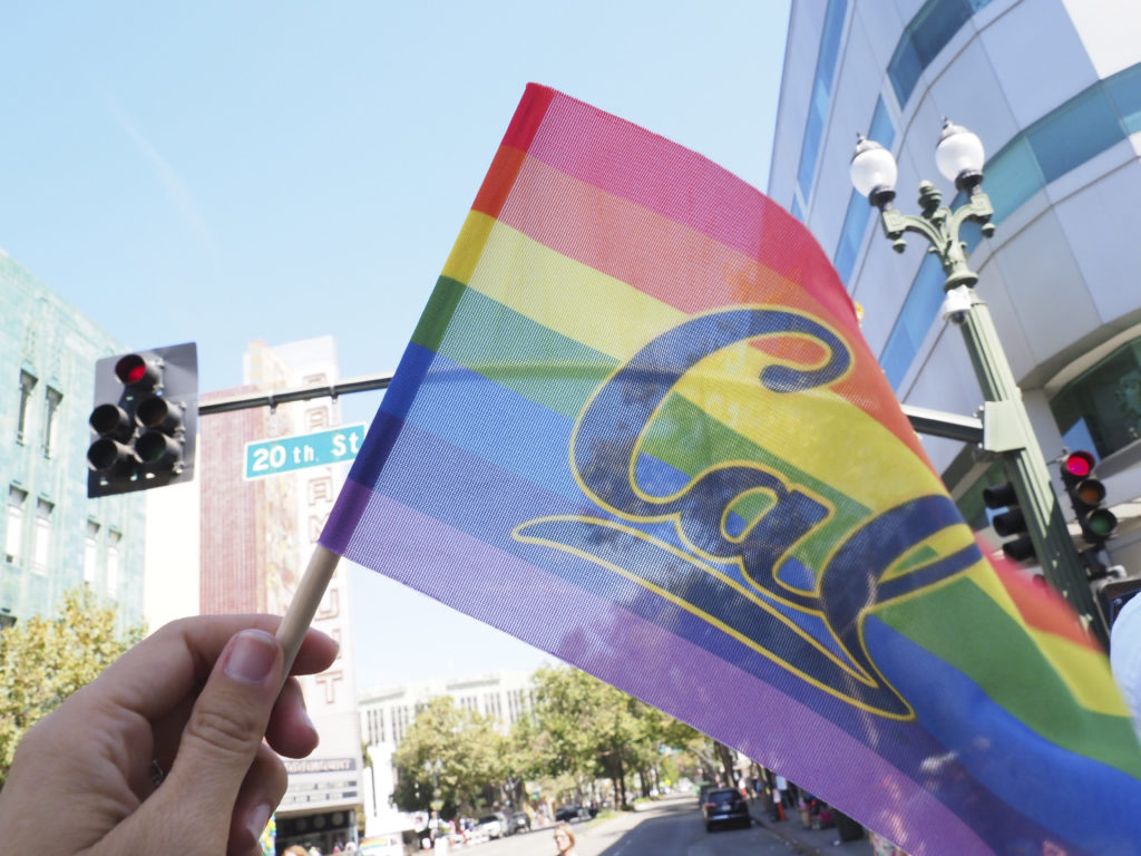 Cal pride flag being waved at the Oakland Pride Parade and Festival