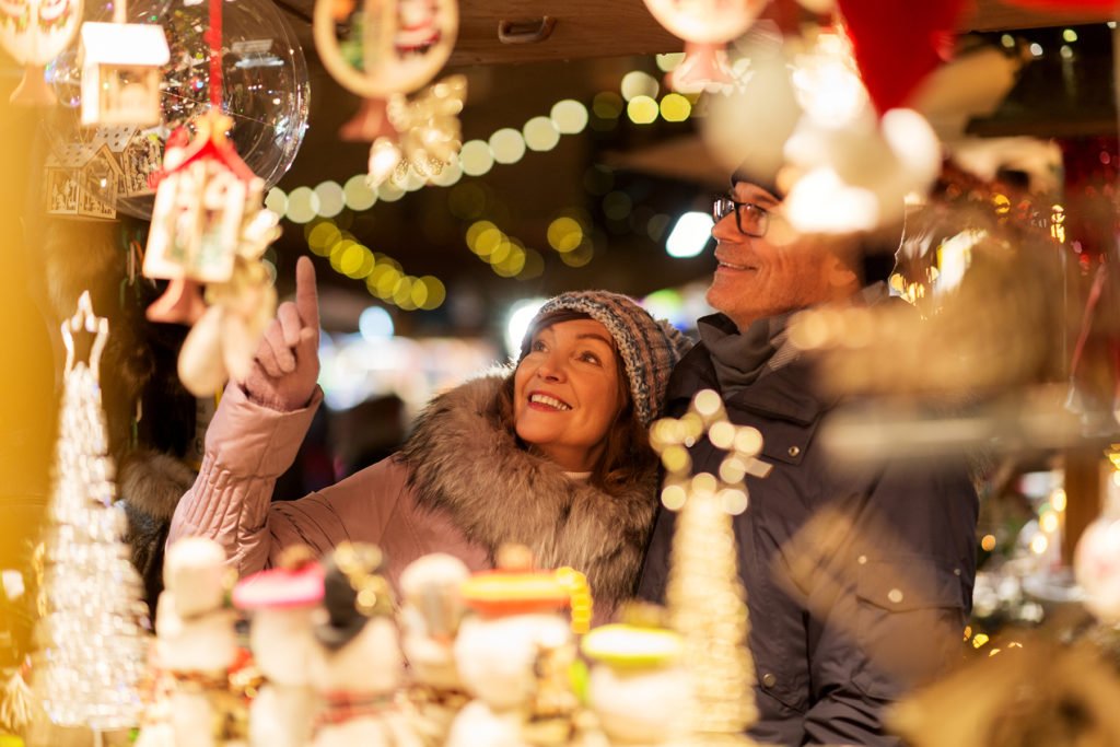 Happy couple at Christmas market souvenir shop