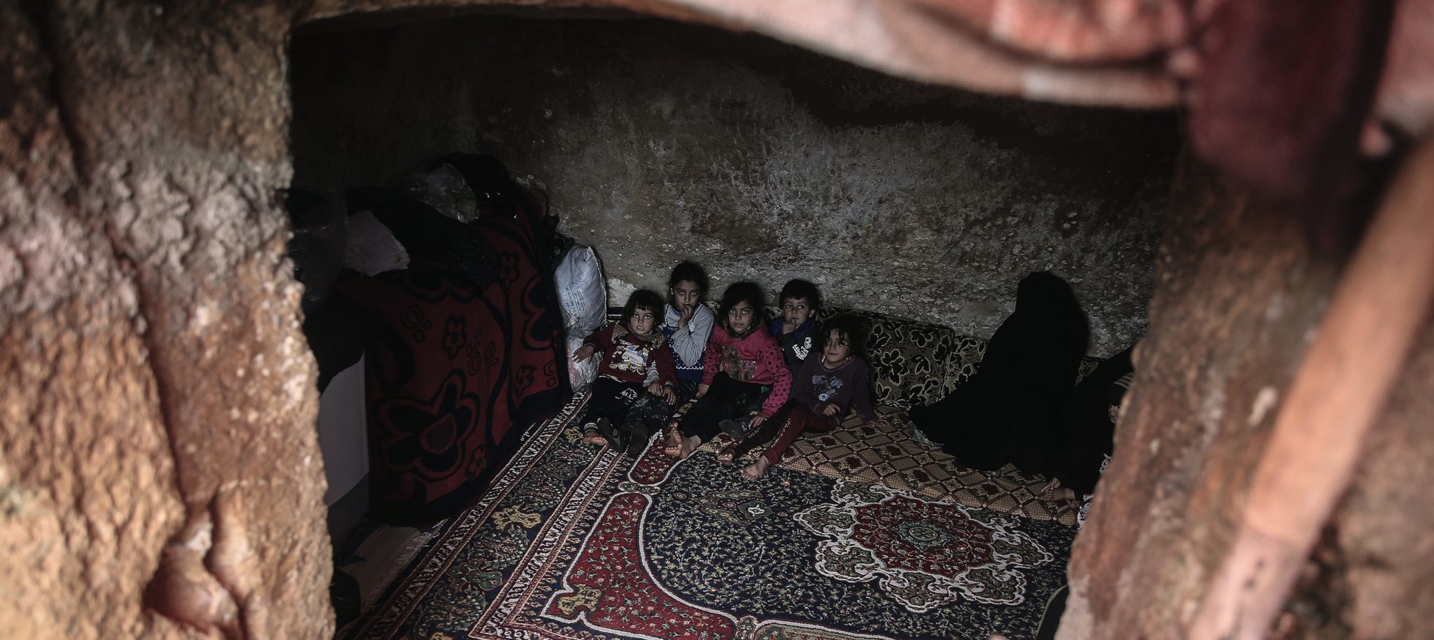 Syrian children are pictured inside a cave