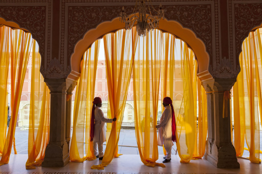 Two people in front of a curtain