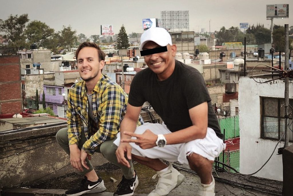 Two men posing on a roof