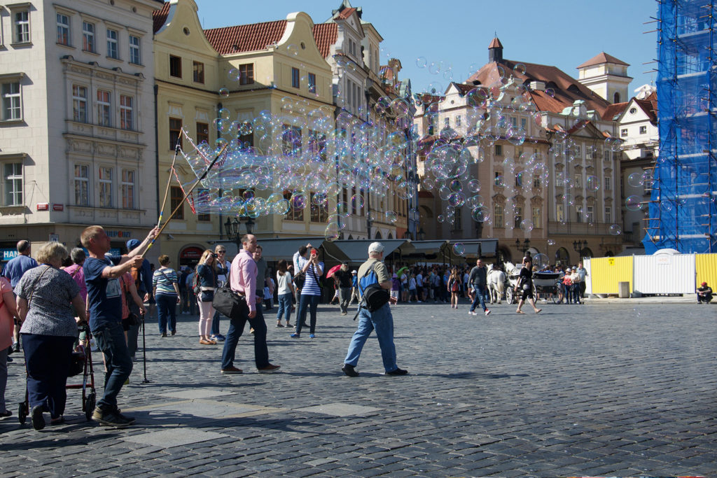 Street performer blowing bubbles in Prague