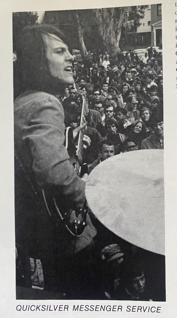 Singer with guitar in front of a crowd