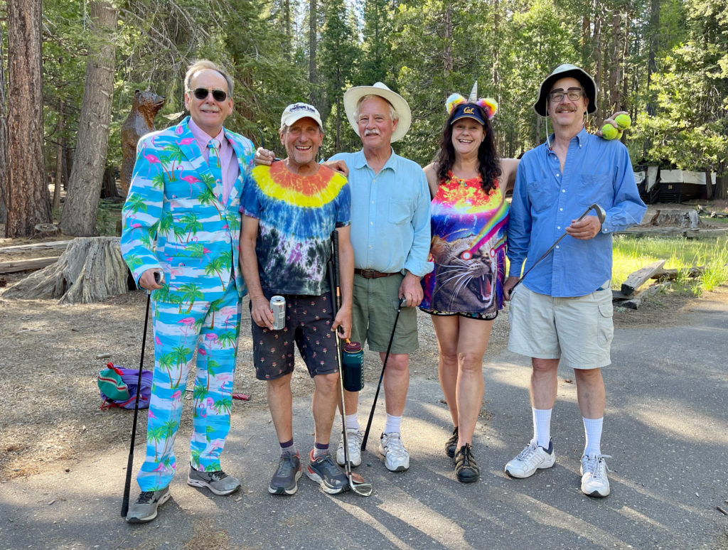 Group of friends dressed in costume with golf clubs