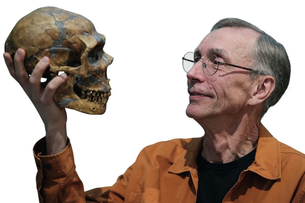 Swedish scientist Svante Paabo poses with a replica of a Neanderthal skeleton at the Max Planck Institute for Evolutionary Anthropology in Leipzig, Germany, Monday, Oct. 3, 2022. 
