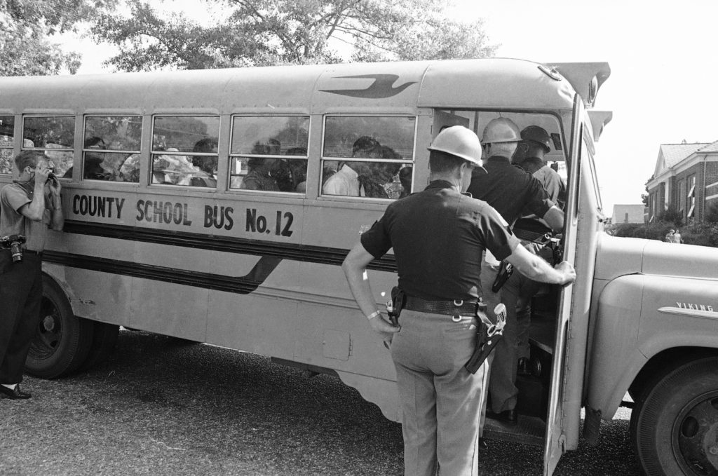 Alabama state troopers turn away a bus with 13 black students inside as they tried to attend Tuskegee High School