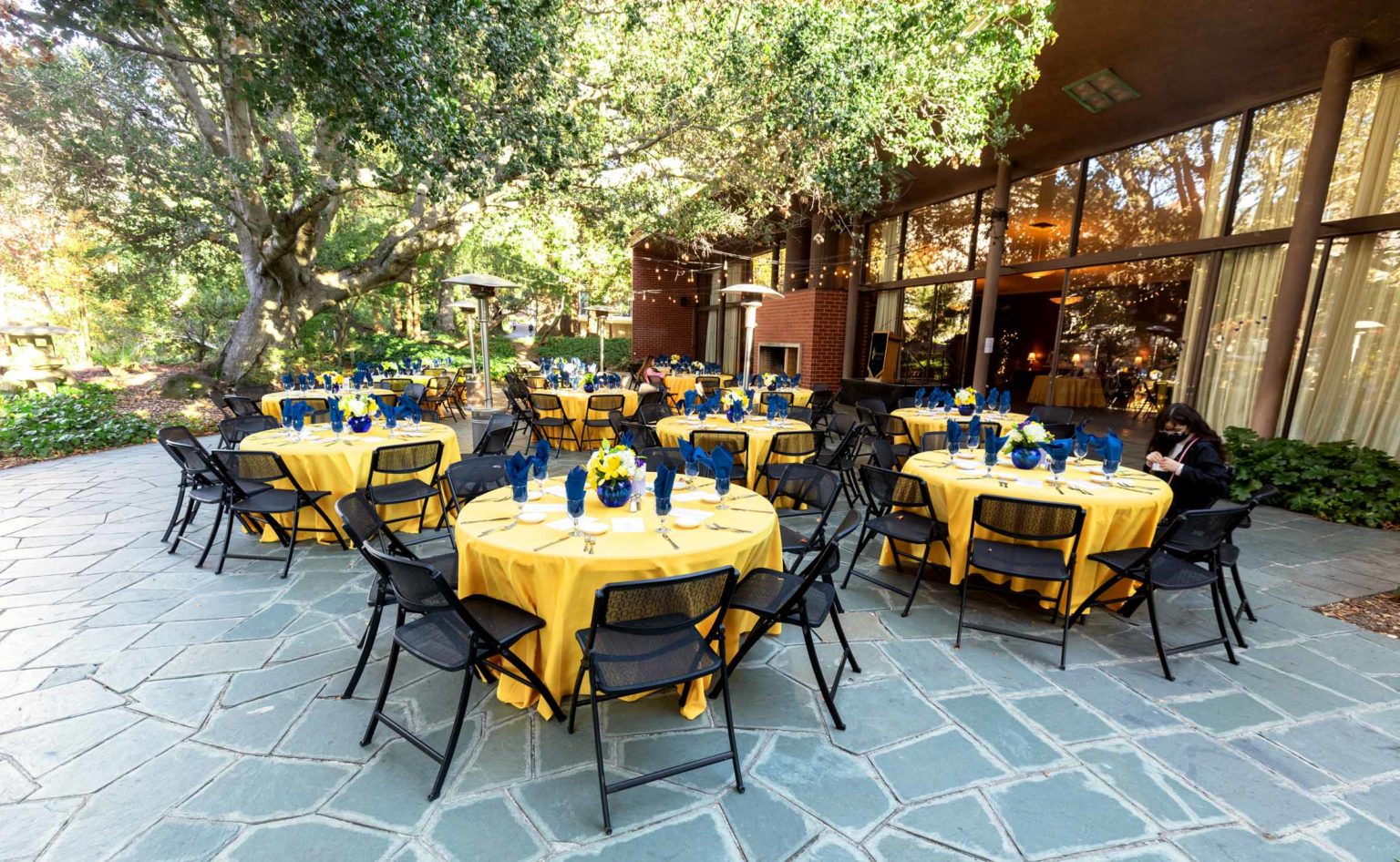 tables set for an event on the alumni house patio