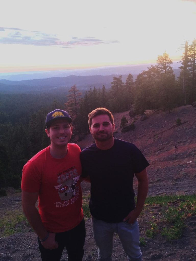 Mikey and Stephen pose in front of the sunset at an overlook in Stanislaus National Forest. 