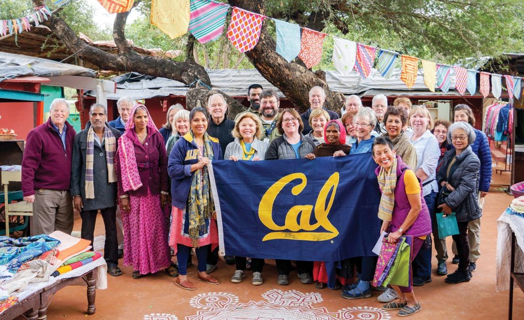 Cal Alumni travelers in India with a Cal banner