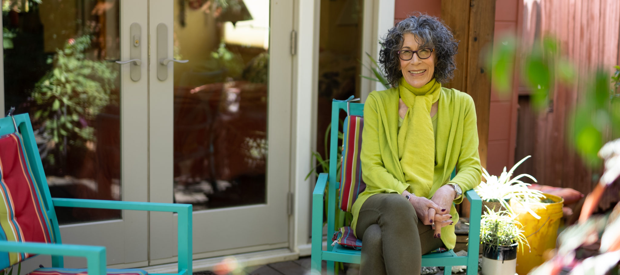 Portrait of Nancy Rubin sitting in backyard home garden