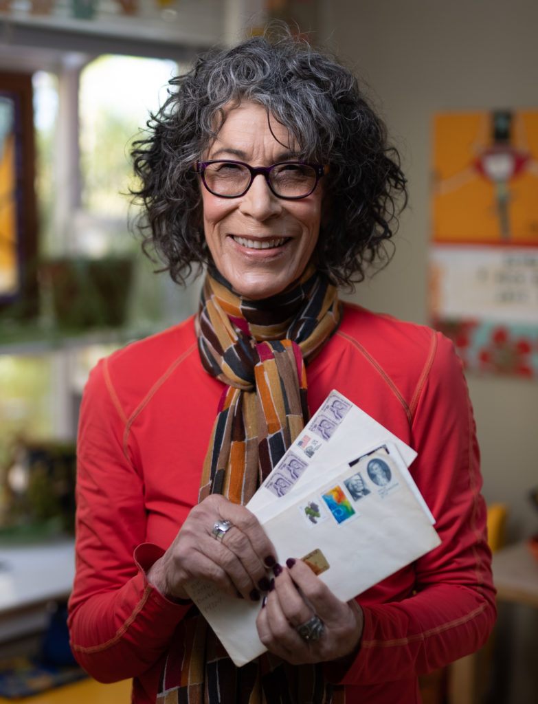 Portrait of Nancy Rubin holding letters