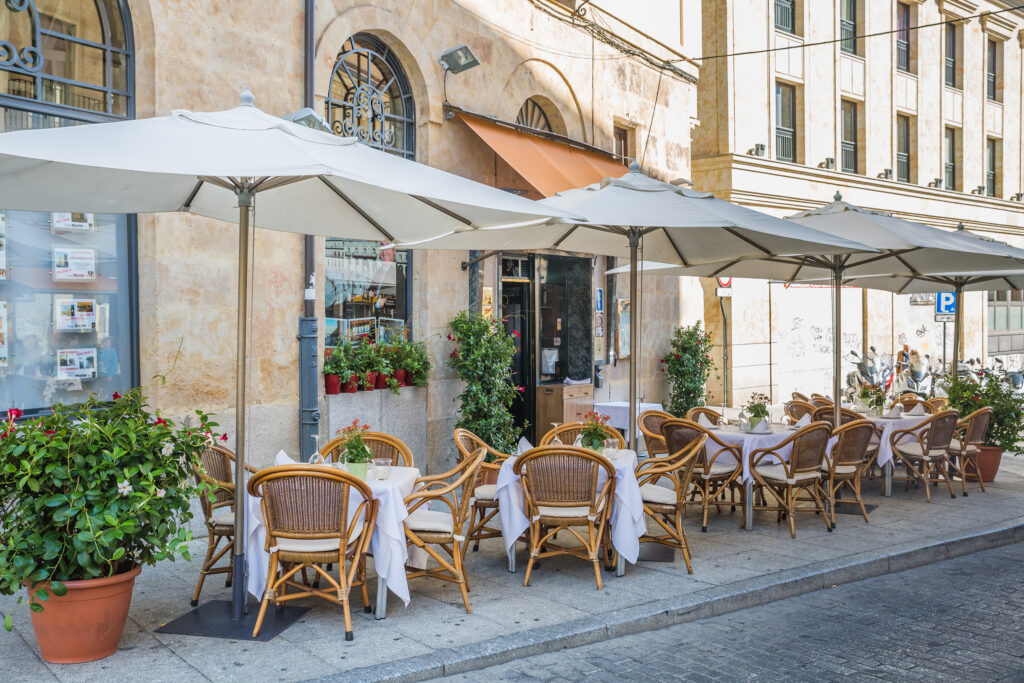 street city cafe with many empty tables in downtown of Salamanca Spain