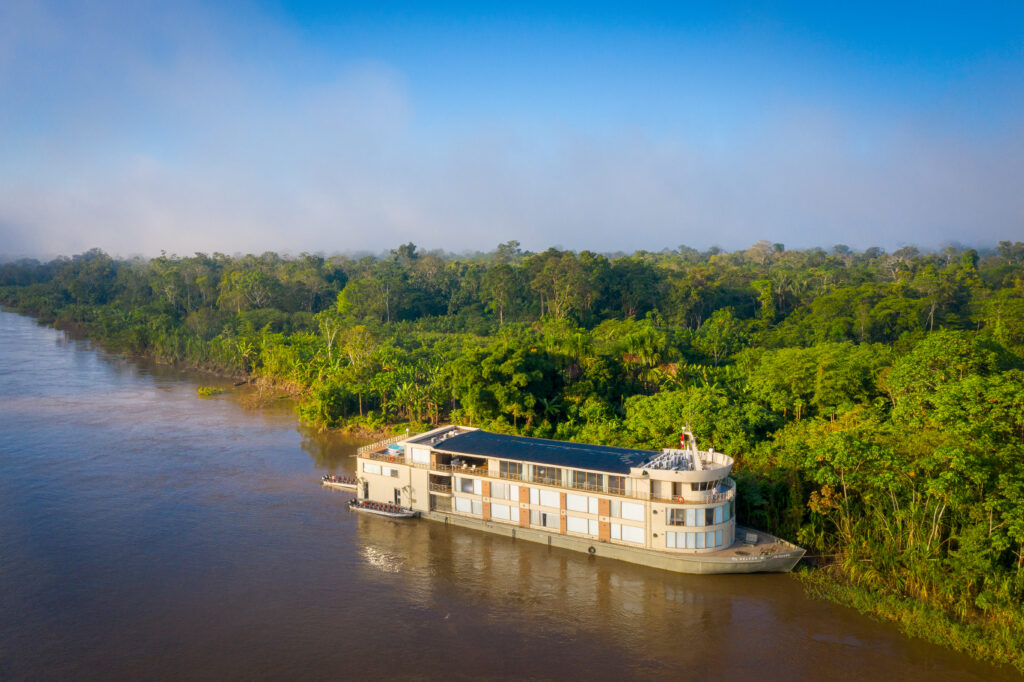 The 170-foot Delfin III ship stops along the shore of the Amazon river.