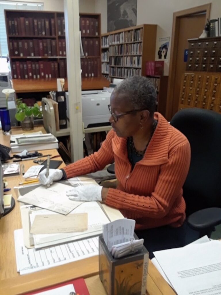 Lazard working the reference desk at the Oakland History Center.