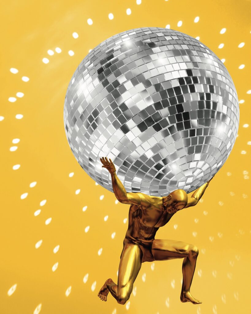 a statue of a man holding up a disco ball