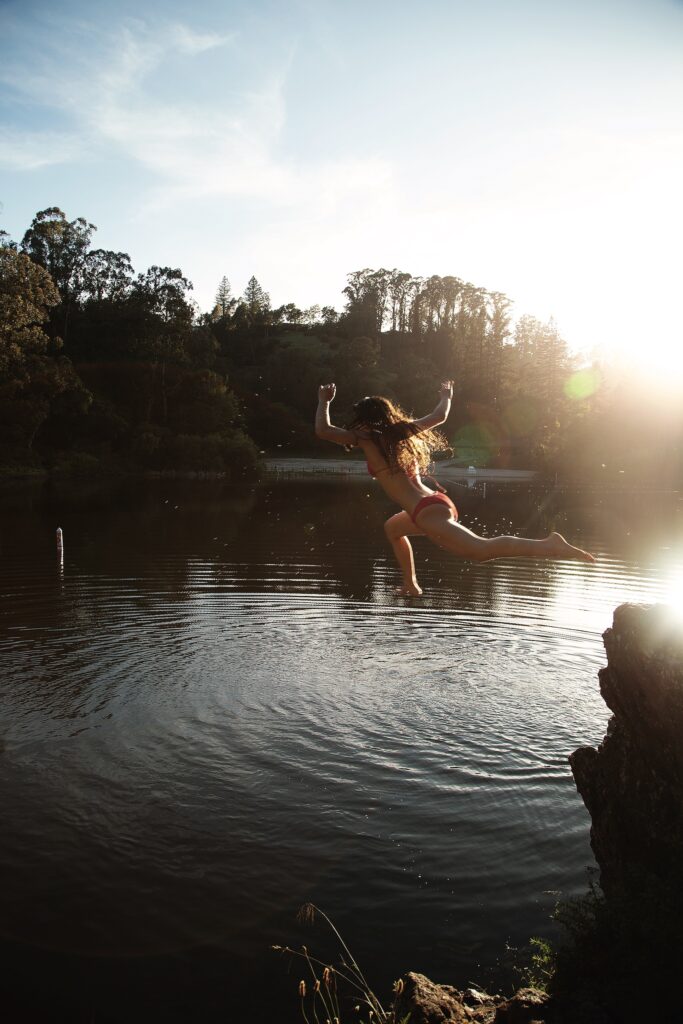 A bather jumps into Lake Anza in Tilden Regional Park