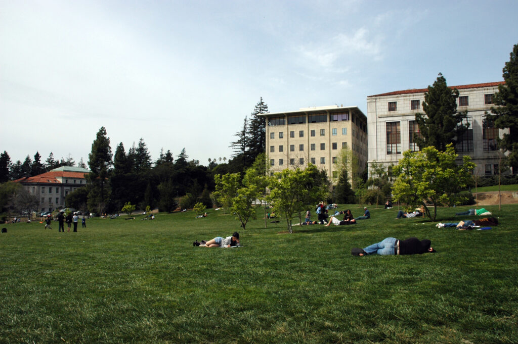 Various students lay on the grassy field of Memorial Glade.