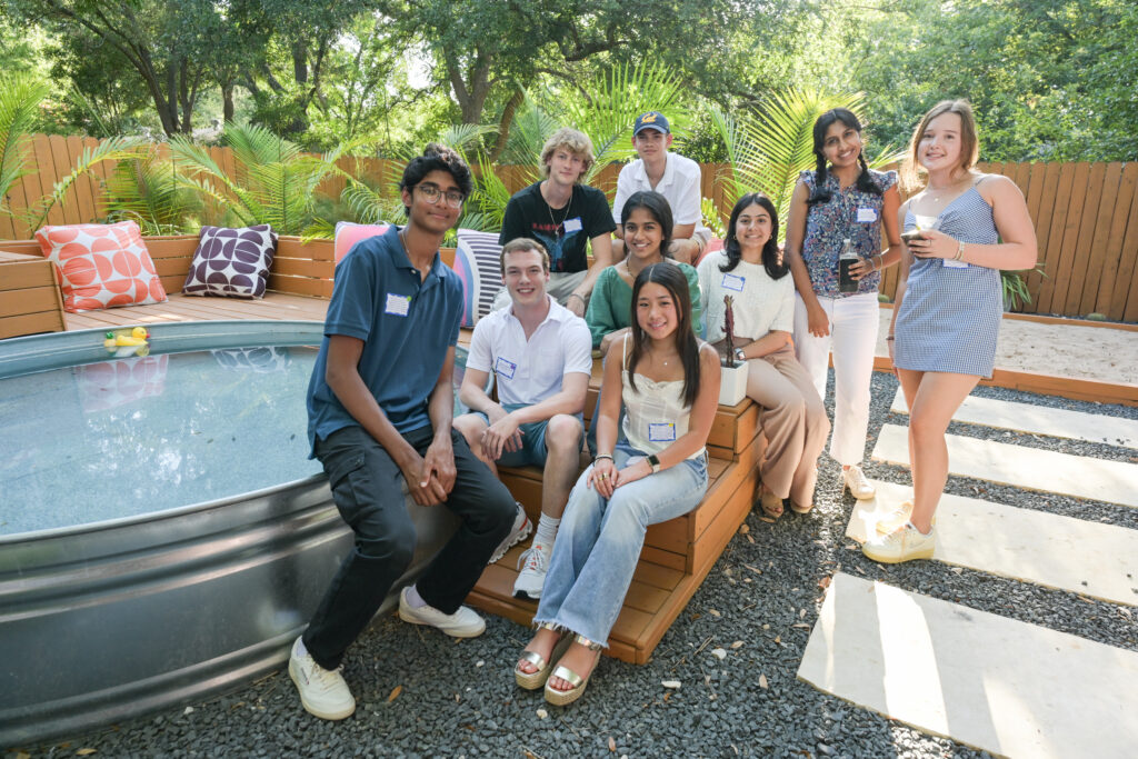Students at the Cal Alumni Club of Austin Summer Welcome Party pose outdoors. 