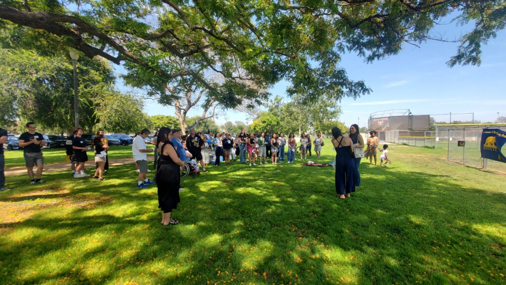 Attendees at the Cal Alumni Club of Long Beach Summer Welcome Party gather at the park. 