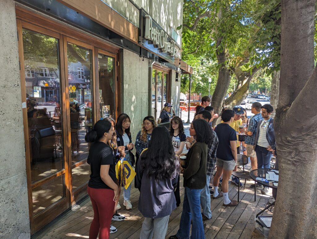 Attendees gather at a coffee shop for the Sac Cal Alumni Summer Welcome Meet-and-Greet. 
