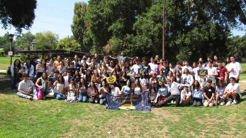 Attendees of the San Gabriel Valley Cal Alumni Club Summer Welcome Picnic pose with Cal signs. 
