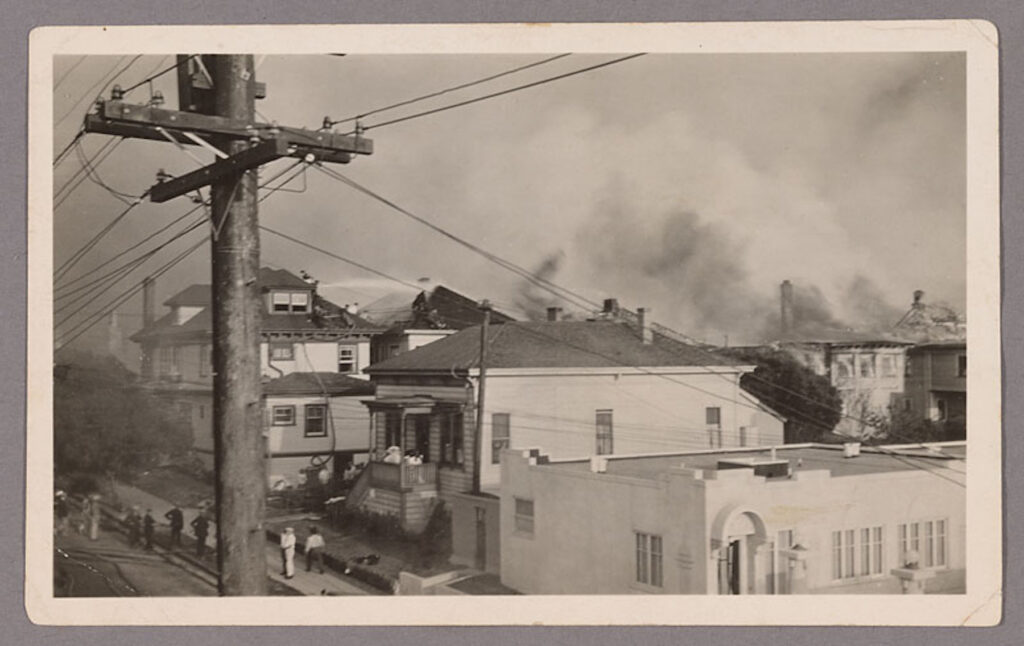 houses in the foreground, fire burning in the background