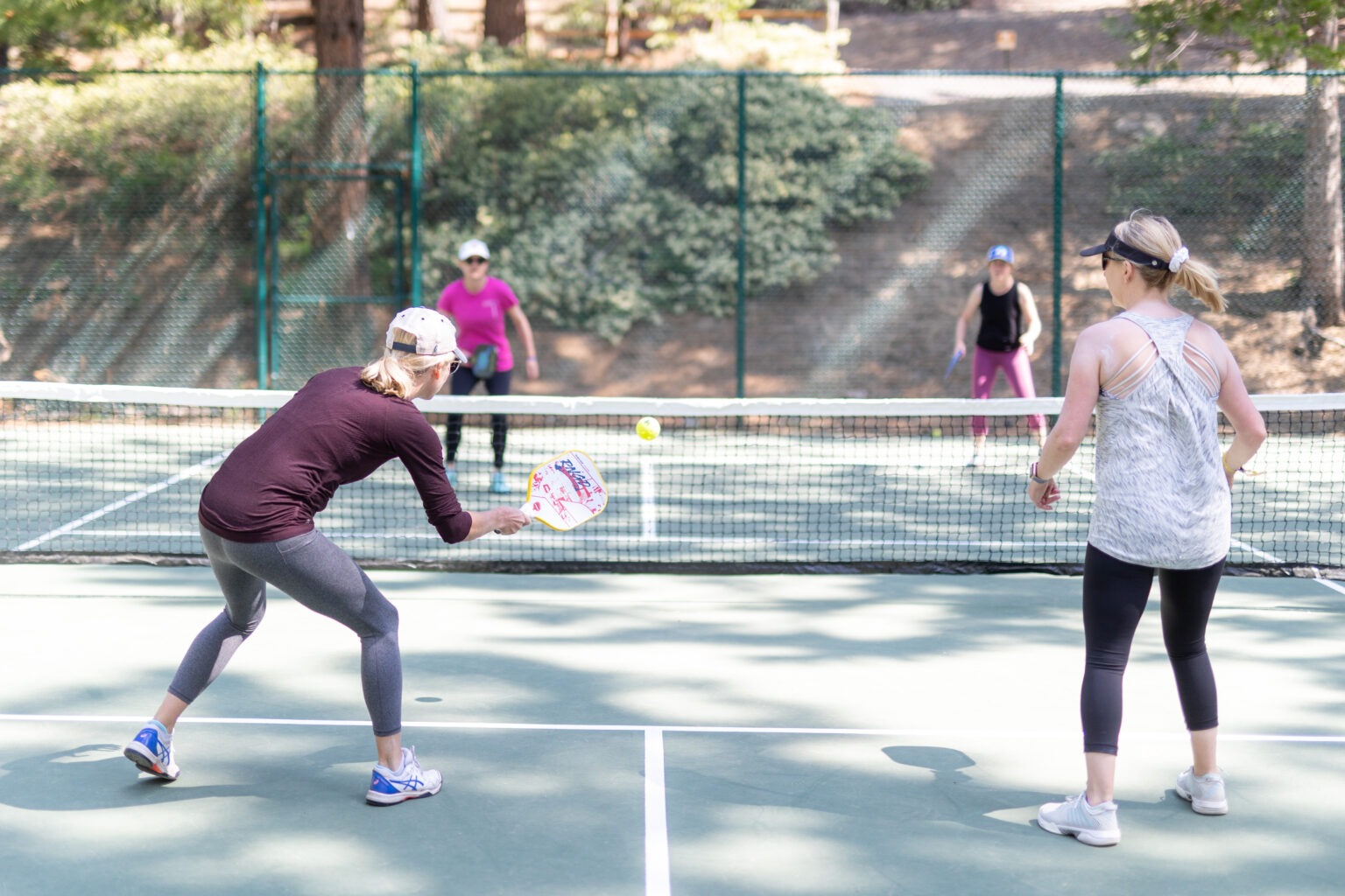 2 teams playing pickleball at the Lair